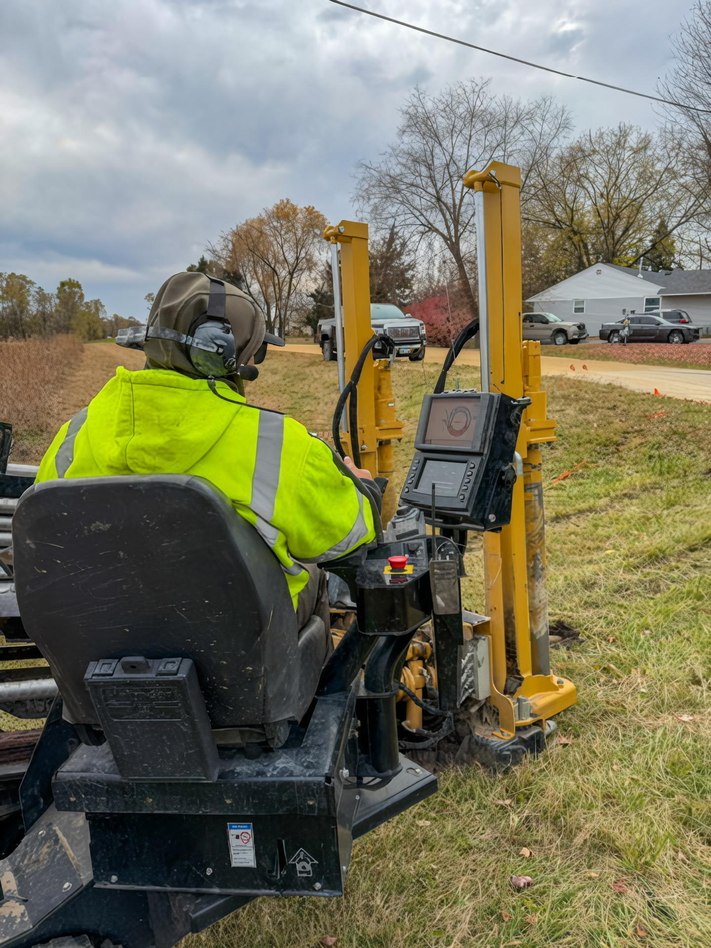 MCI operator running HDD equipment with locating gear in a field